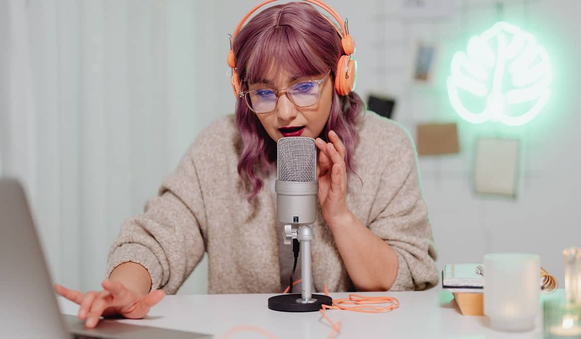 How to become an influencer - image shows a woman recording a podcast