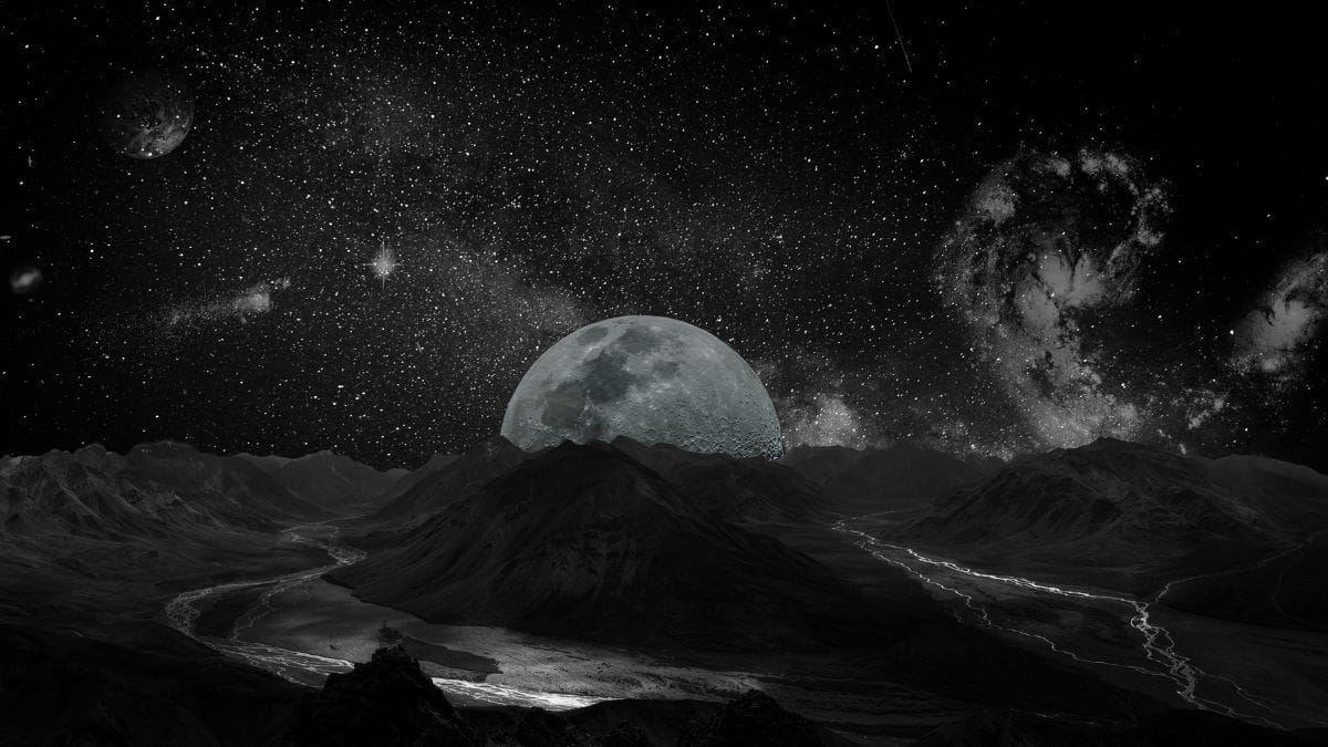 Worldbuilding For Creative Writing - image shows a black and white landscape under a moonlit sky